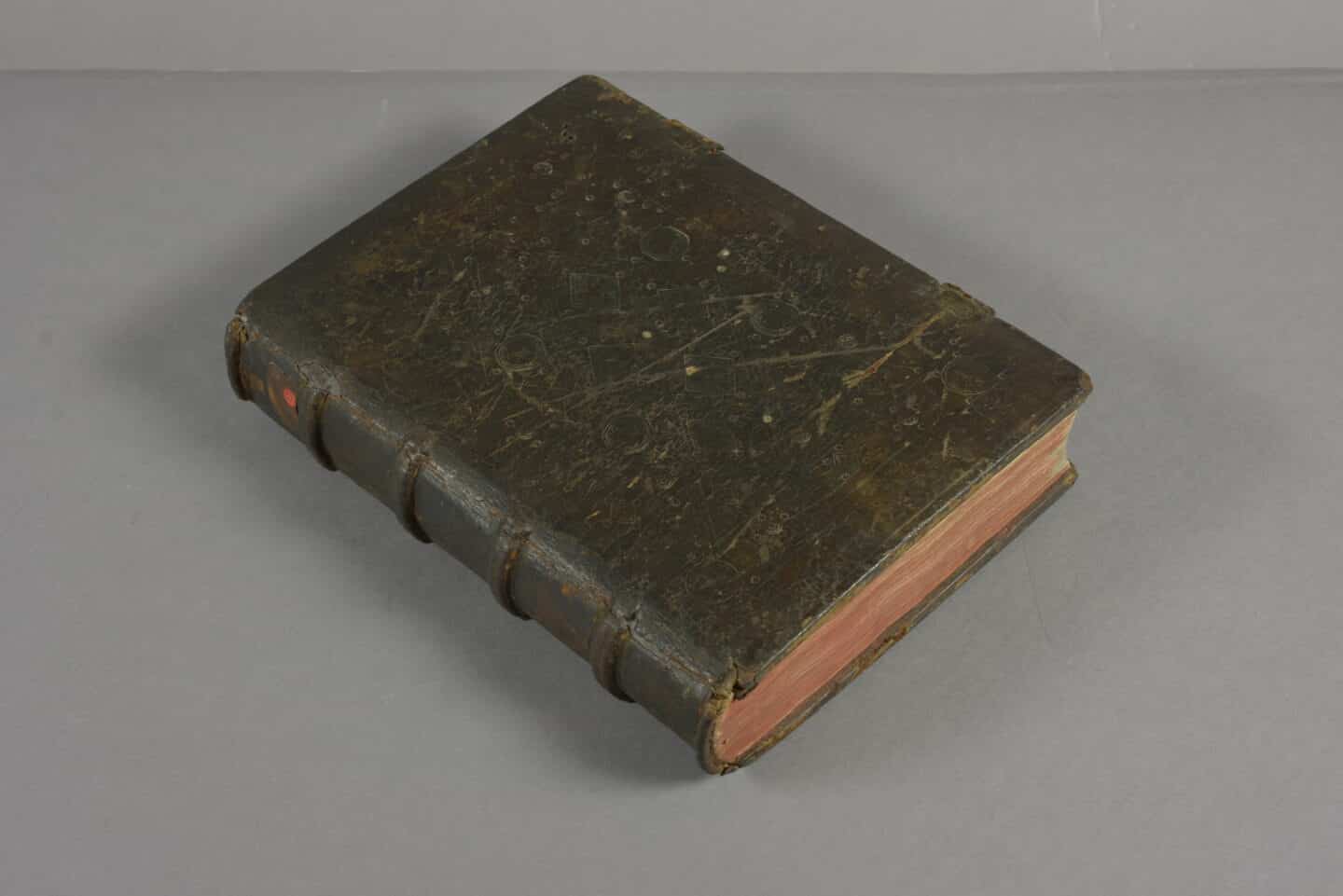 A closed 15th century book with leather binding over wooden boards